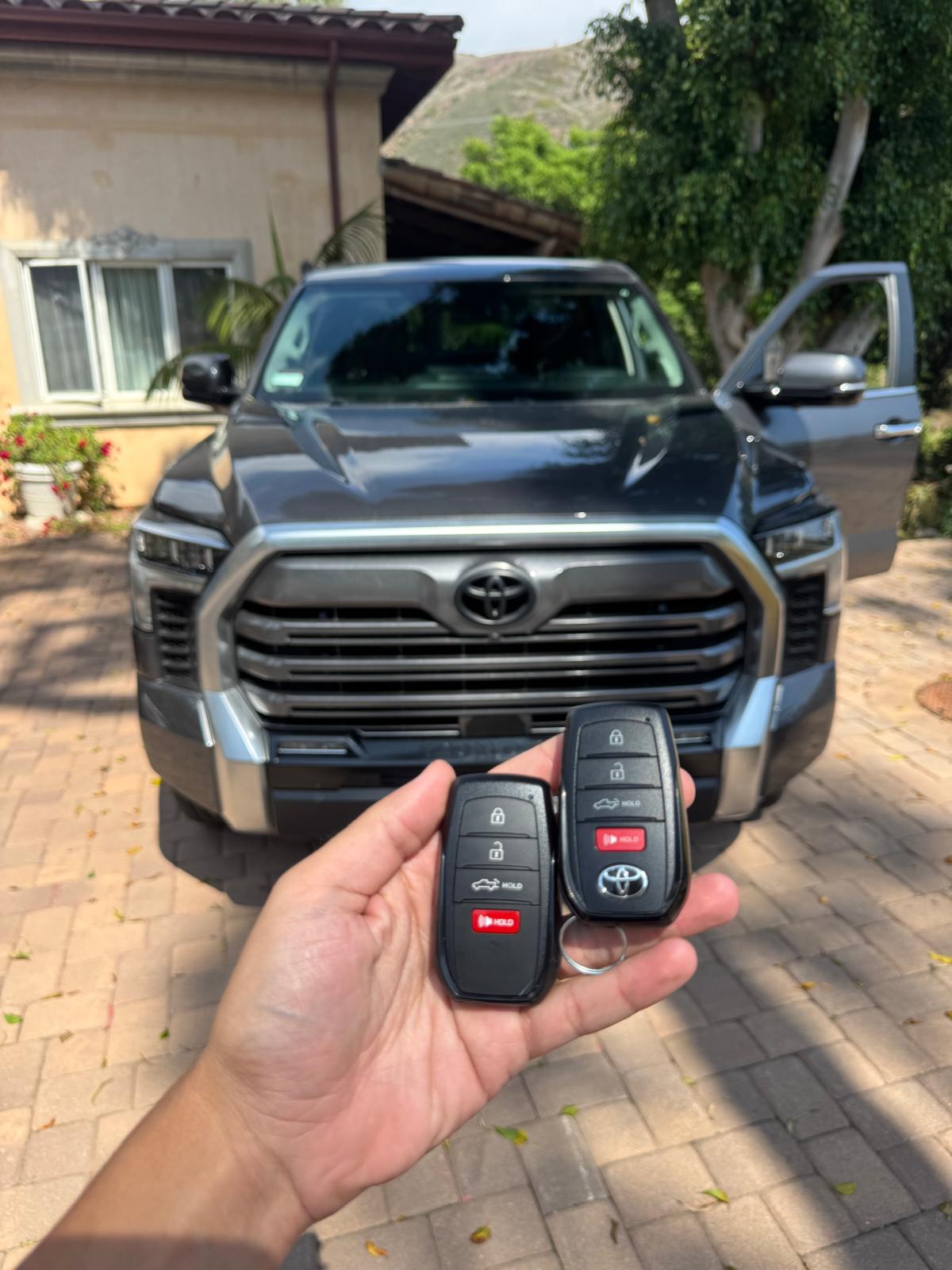 Toyota key fobs in front of a pickup